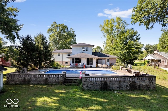 view of swimming pool featuring a yard and a patio area