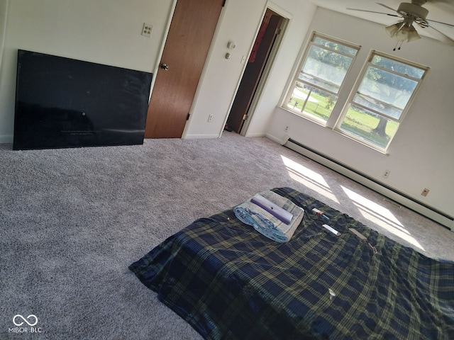 bedroom featuring ceiling fan, a baseboard heating unit, and carpet flooring