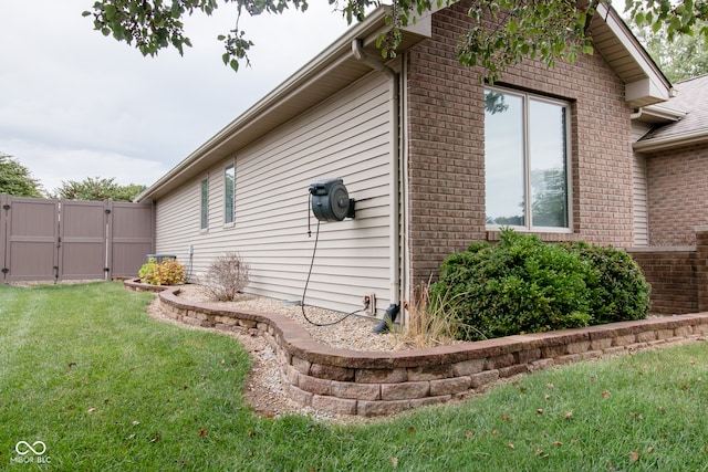 view of side of property with a yard