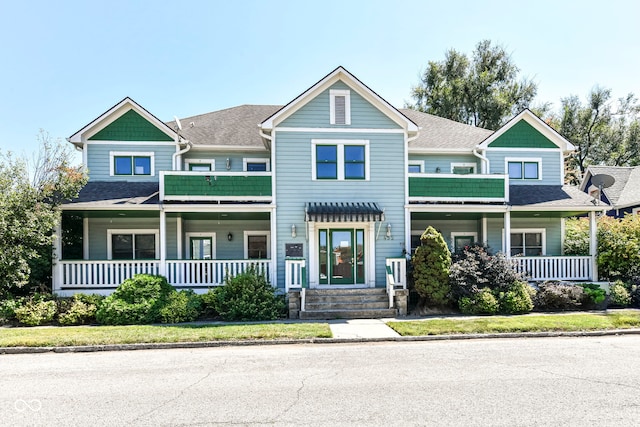 view of front of house with covered porch and a shingled roof