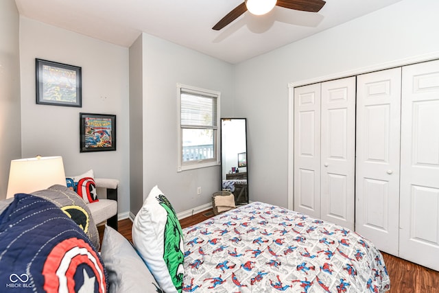 bedroom with dark hardwood / wood-style flooring, a closet, and ceiling fan