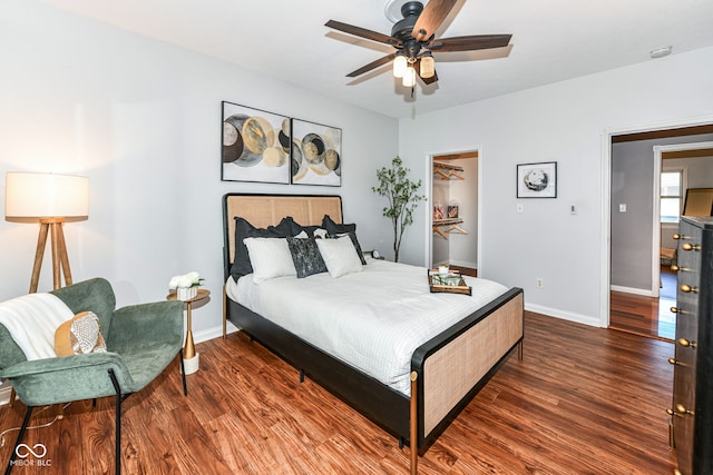 bedroom with dark hardwood / wood-style flooring and ceiling fan