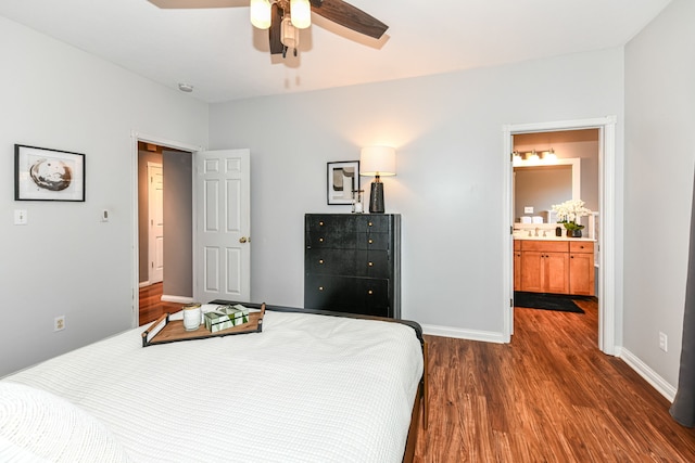 bedroom featuring ensuite bathroom, dark hardwood / wood-style floors, and ceiling fan