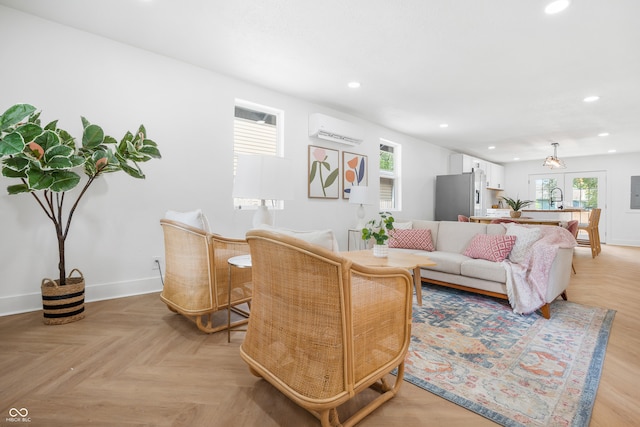 living room with a wall mounted AC and light parquet flooring