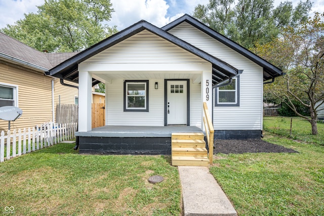 bungalow-style house featuring a porch and a front yard