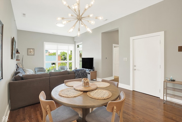 dining room featuring a notable chandelier and dark hardwood / wood-style flooring