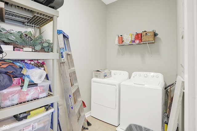 laundry room featuring washing machine and clothes dryer and light tile patterned flooring