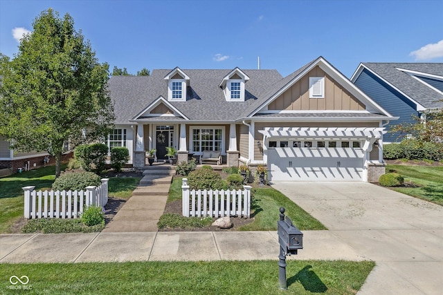 craftsman inspired home featuring a front yard, a garage, and a porch