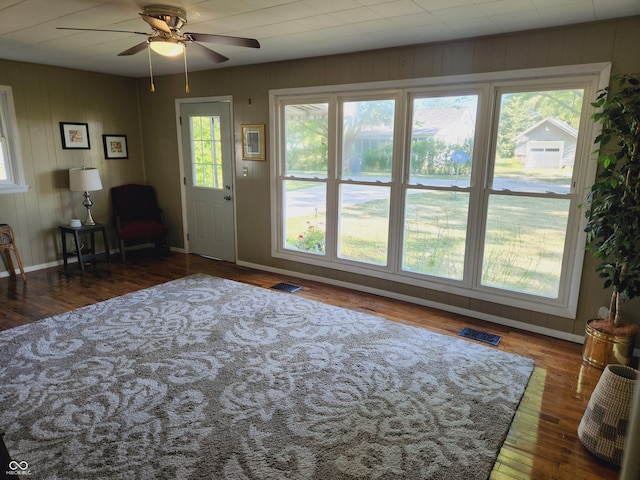 interior space with ceiling fan and dark hardwood / wood-style floors