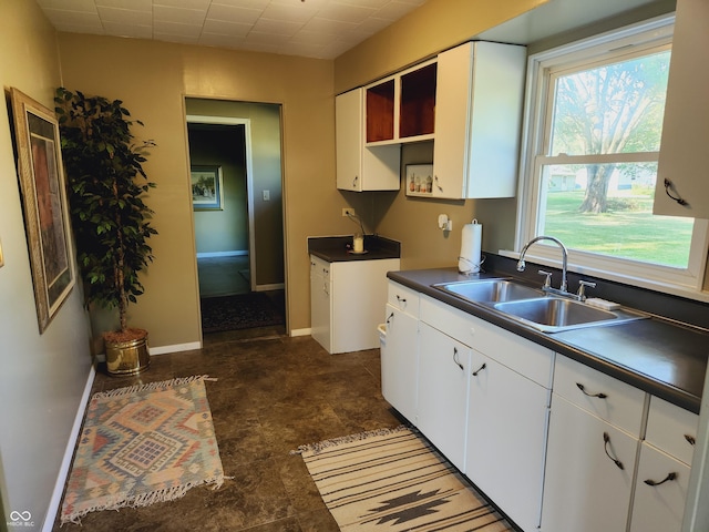 kitchen with white cabinetry and sink