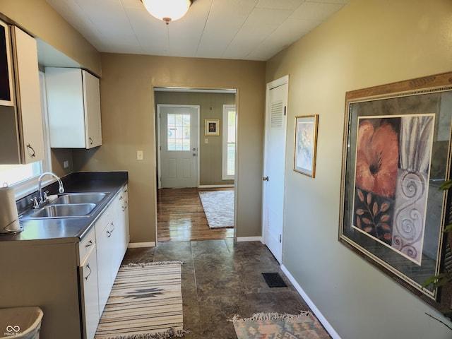 kitchen featuring sink and white cabinets