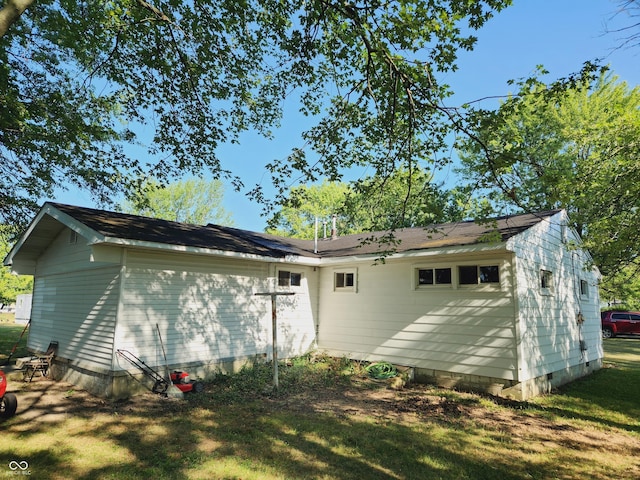 rear view of property with a yard