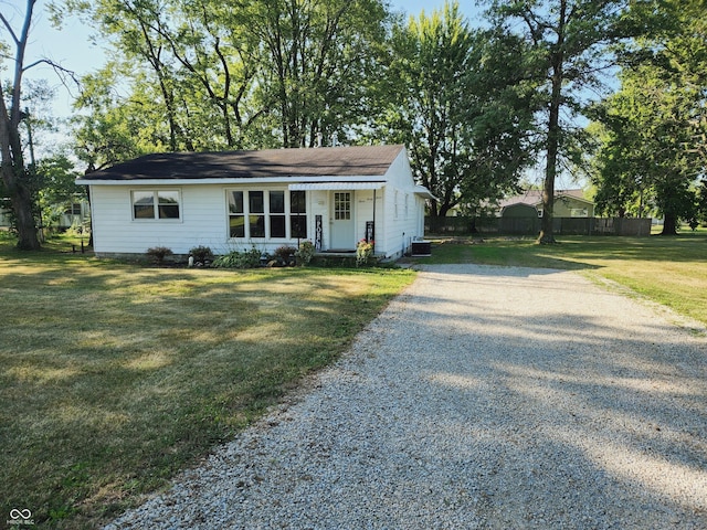 view of front of property featuring central AC unit and a front lawn