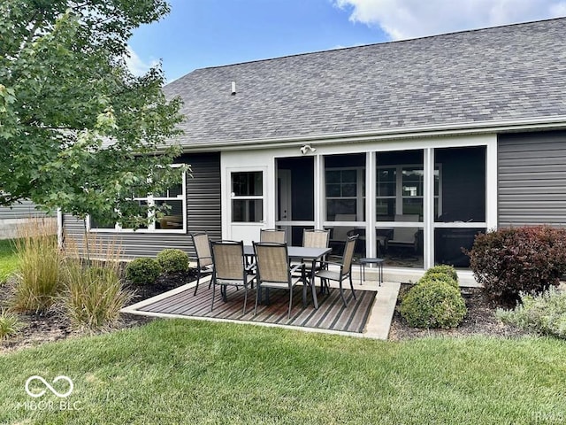 back of house with a patio and a lawn