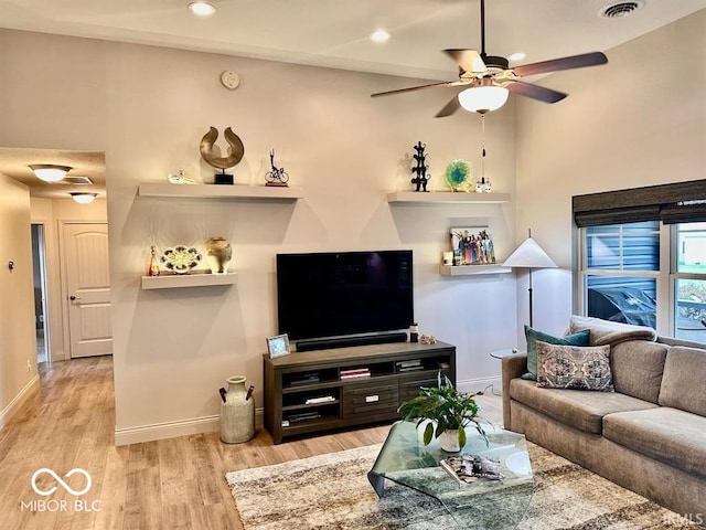 living room featuring ceiling fan and light wood-type flooring