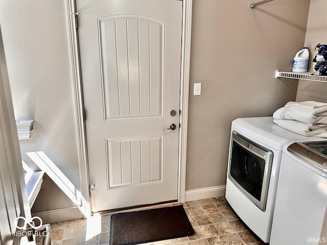 clothes washing area with tile patterned flooring and separate washer and dryer