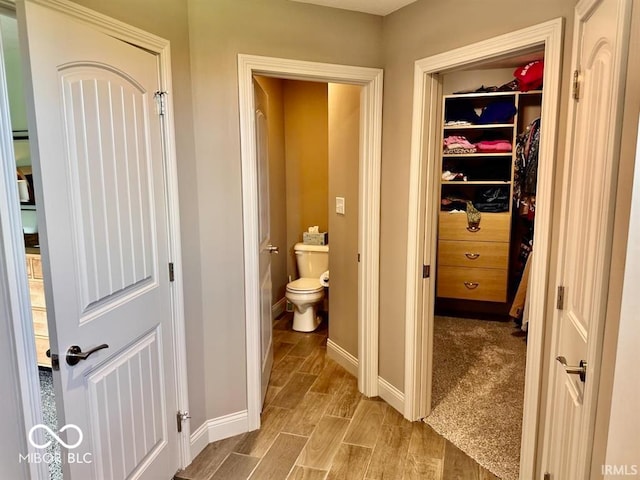 interior space featuring toilet and hardwood / wood-style flooring