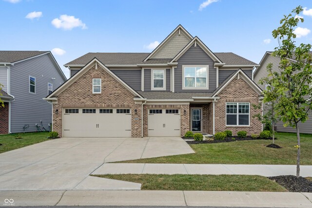 craftsman inspired home featuring a front yard and a garage