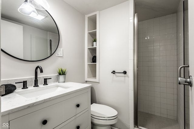 bathroom with toilet, walk in shower, and vanity