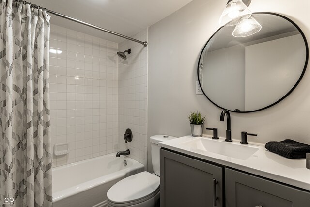 full bathroom with vanity, shower / tub combo, and toilet