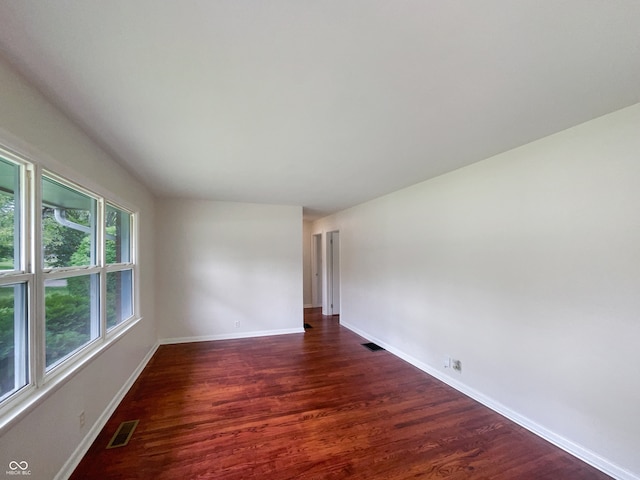 empty room with dark wood-type flooring