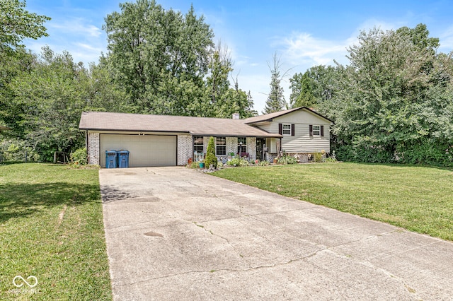 tri-level home featuring a garage and a front lawn