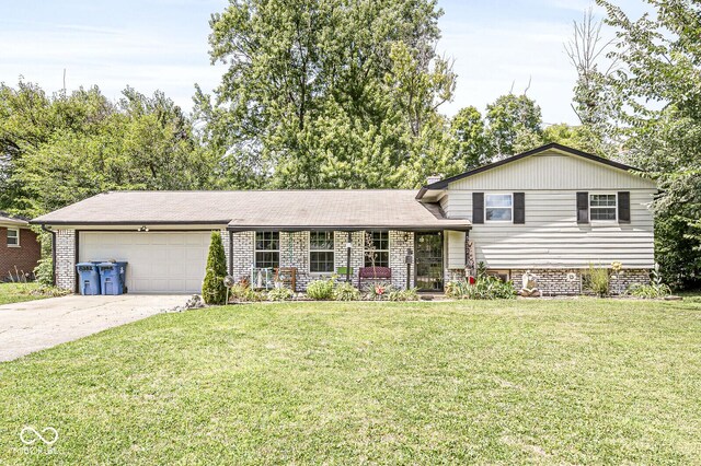 split level home with a front lawn and a garage