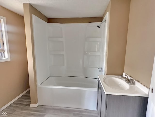 bathroom with vanity, a textured ceiling, shower / tub combination, and hardwood / wood-style flooring