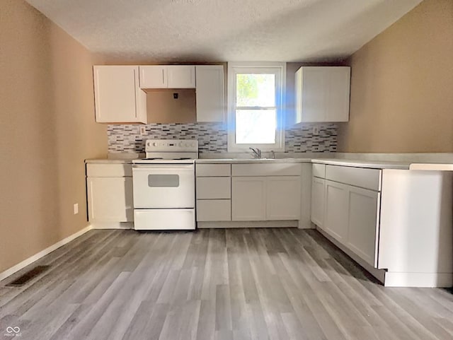 kitchen with white cabinets, white electric range, a textured ceiling, and light hardwood / wood-style flooring