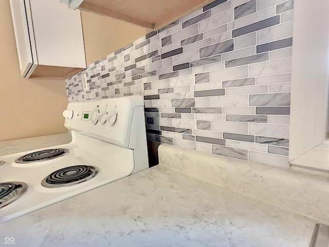 details featuring white electric range oven and light stone countertops