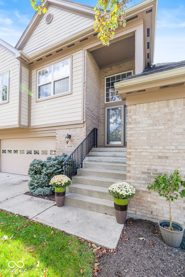 view of exterior entry with a garage