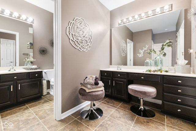 bathroom featuring vanity, tile patterned floors, and toilet