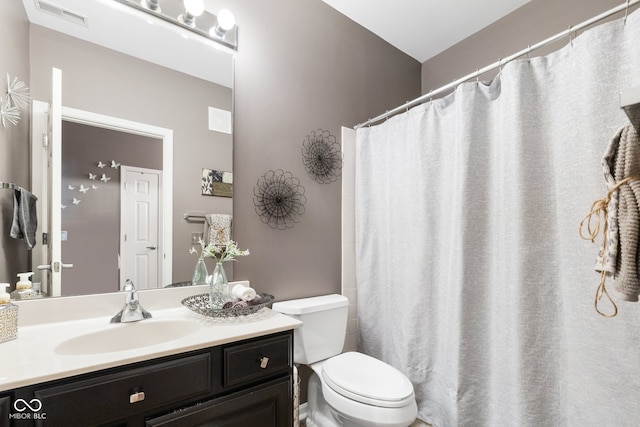 bathroom with vanity, a shower with curtain, and toilet