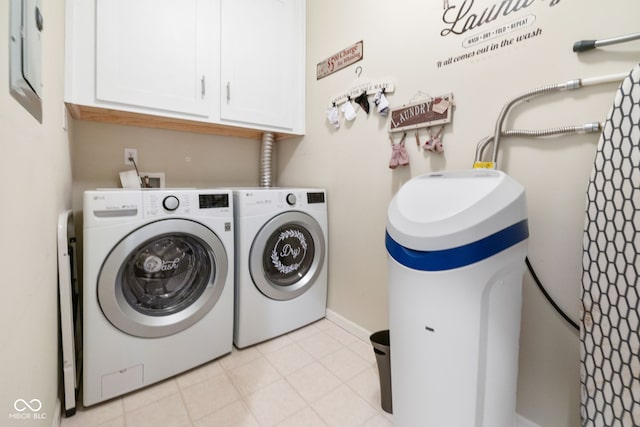 clothes washing area featuring cabinets and separate washer and dryer