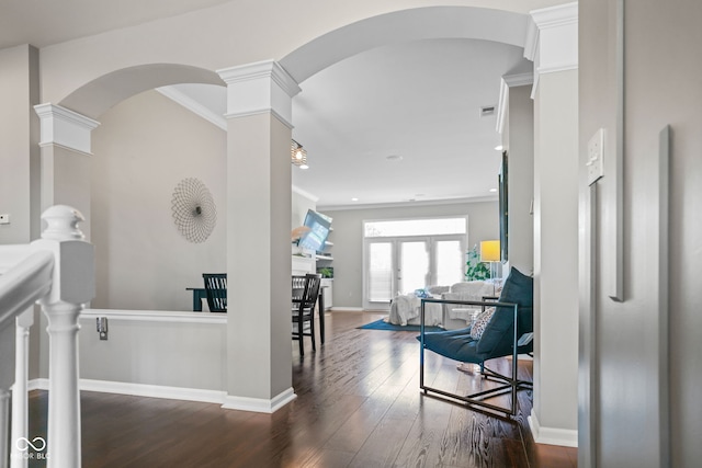 hallway with dark hardwood / wood-style flooring, ornamental molding, and decorative columns