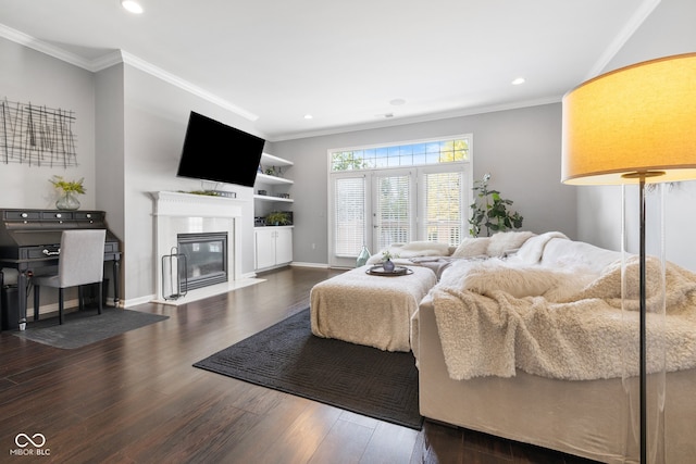 bedroom featuring crown molding, wood-type flooring, and a high end fireplace