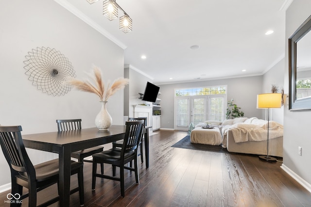 dining area with ornamental molding and dark hardwood / wood-style floors