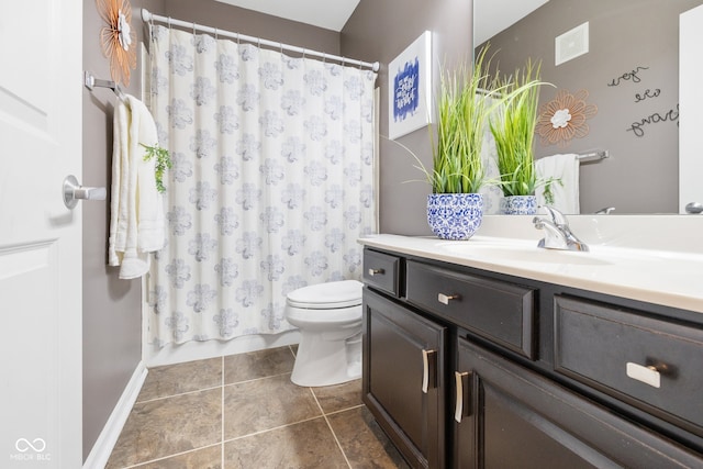 bathroom with vanity, curtained shower, toilet, and tile patterned floors