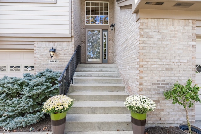 view of exterior entry with a garage