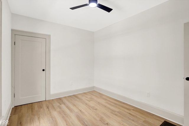 spare room featuring light hardwood / wood-style flooring and ceiling fan