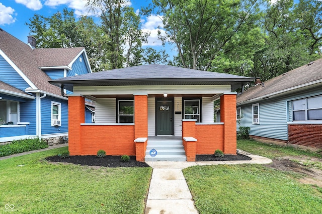 bungalow featuring a front lawn and a porch