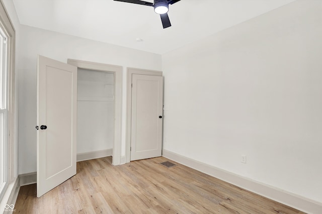 unfurnished bedroom featuring ceiling fan, a closet, and light hardwood / wood-style floors