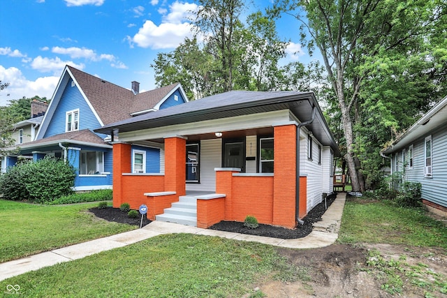 view of front of property with covered porch and a front lawn