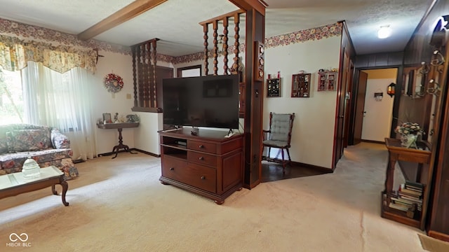 living room with beamed ceiling, a textured ceiling, and light colored carpet