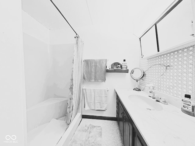 bathroom with vanity and tile walls