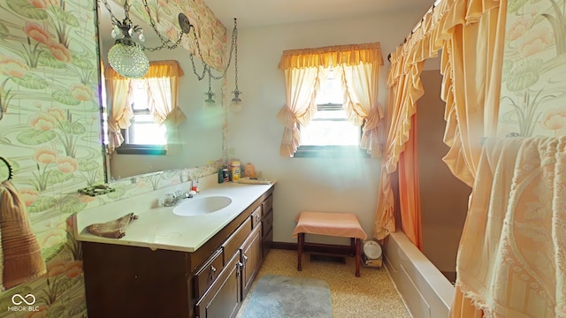 bathroom with vanity, plenty of natural light, and shower / bath combo