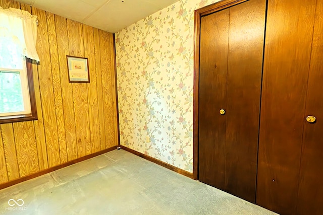 unfurnished room with wood walls