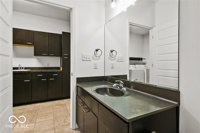 bathroom with vanity and washer and dryer