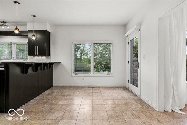 kitchen featuring decorative light fixtures, kitchen peninsula, and a breakfast bar