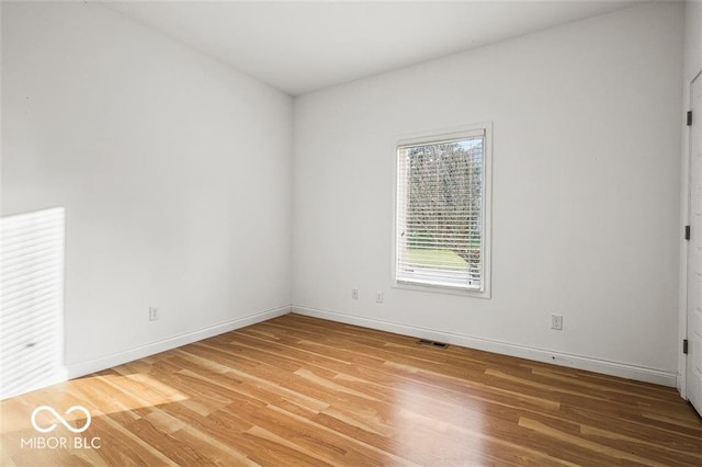 unfurnished room with wood-type flooring